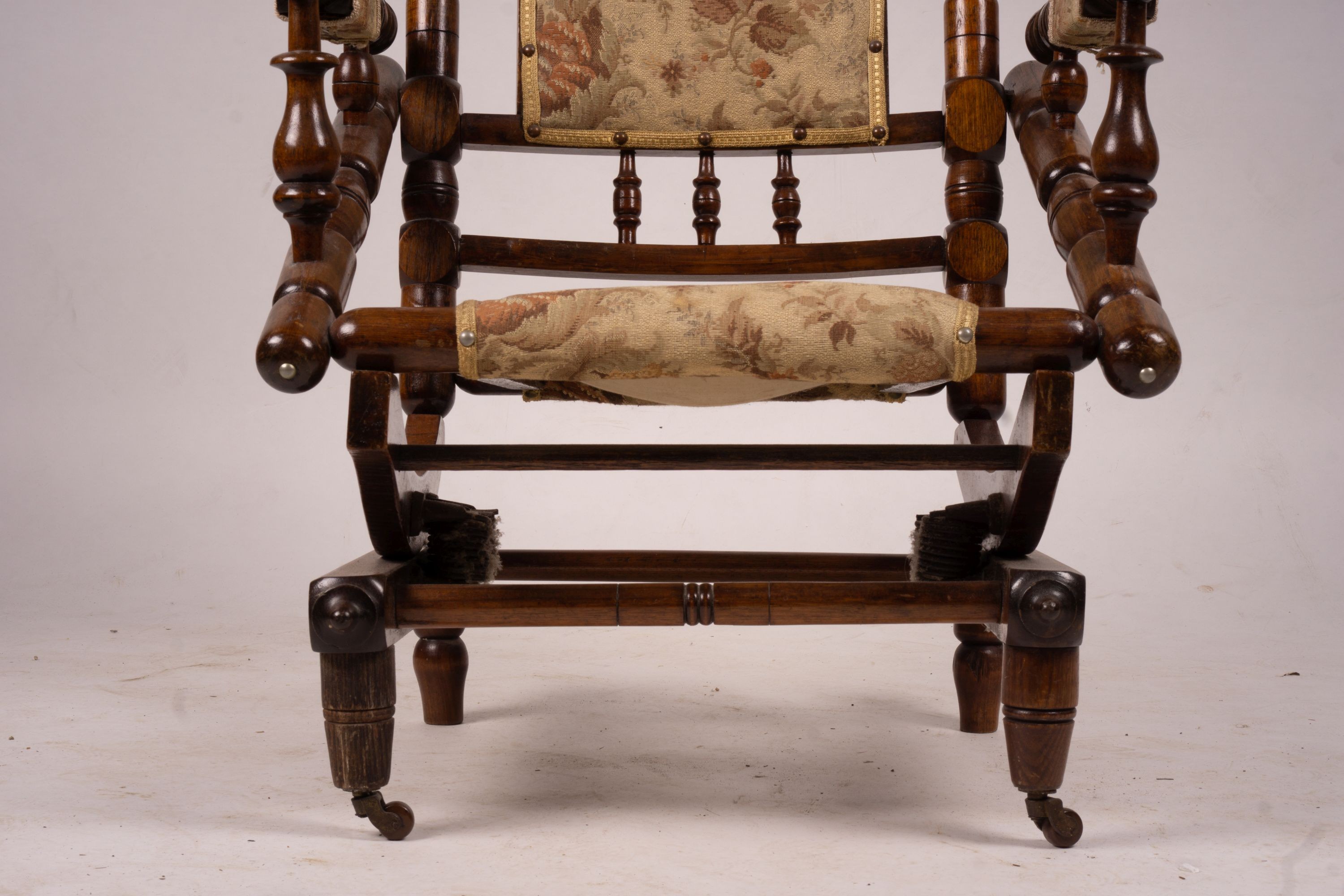 An early 20th century American turned mahogany rocking chair